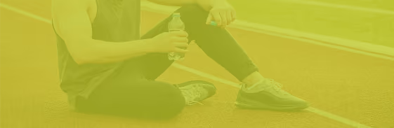 Athlete resting on a running track after training
