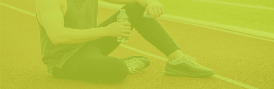 Athlete resting on a running track after training