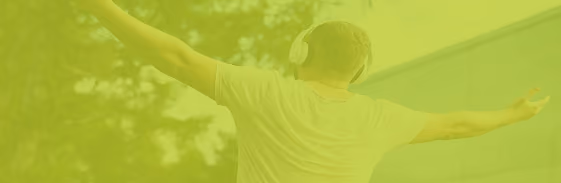Person relaxing outdoors with headphones
