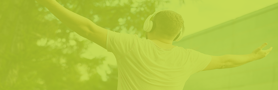 Person relaxing outdoors with headphones