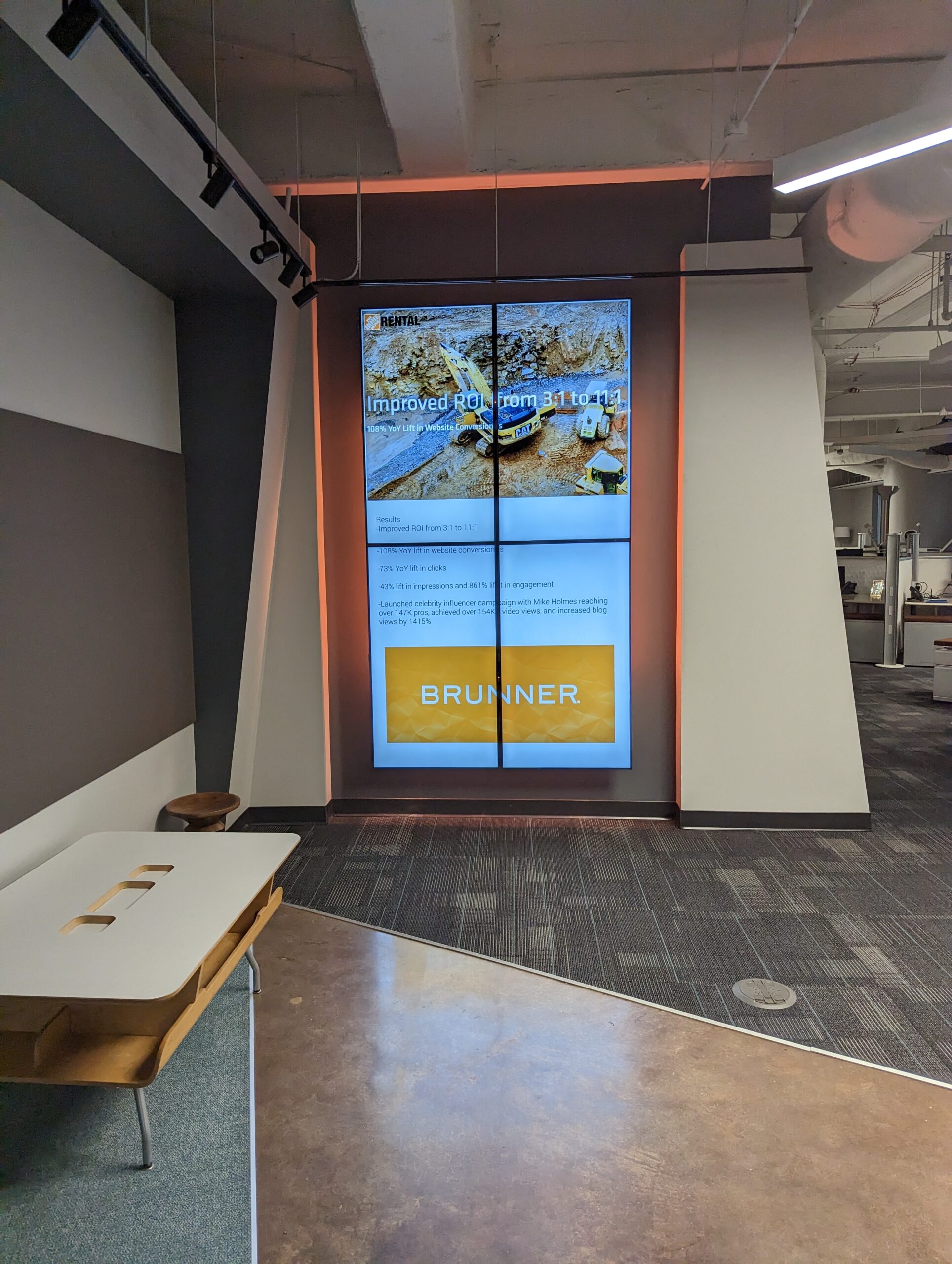 Brunner digital signage display wall showing branded agency content