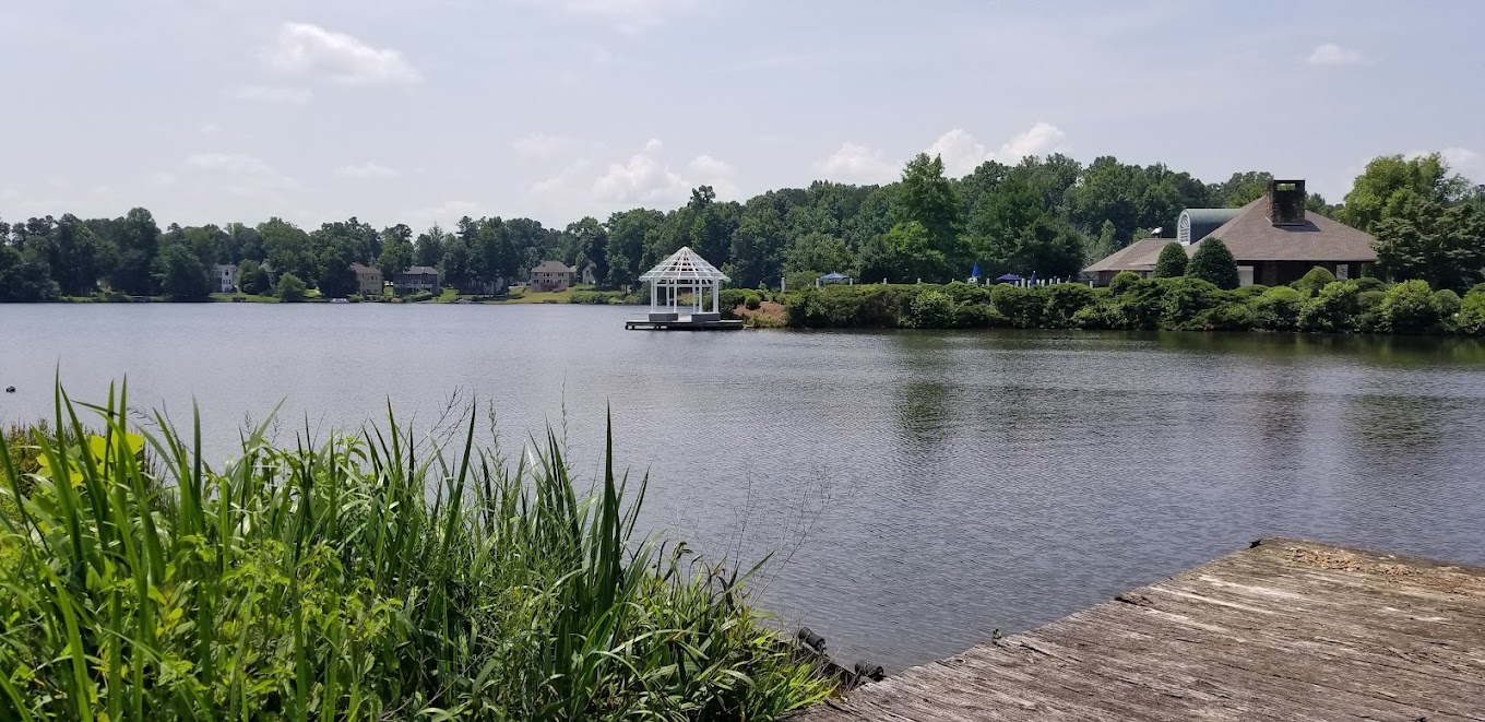 Waters Edge lake with dock, pavilion, landscaping, and community buildings in Stone Mountain, Georgia
