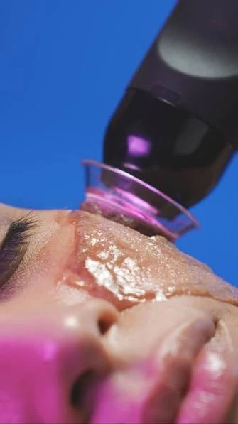 Facial treatment handpiece applied to the cheek