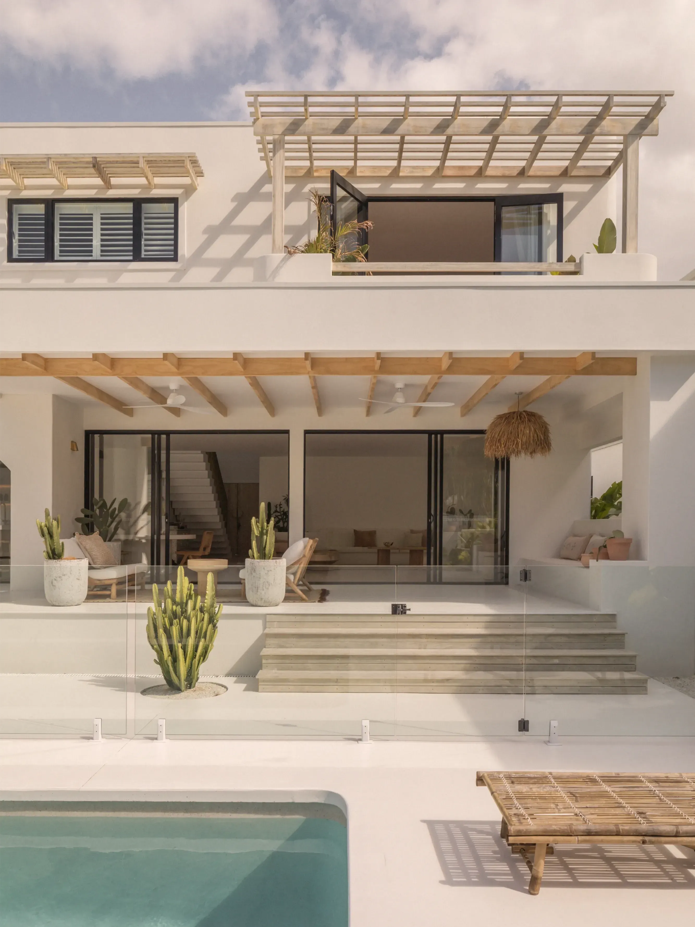 White coastal home with an outdoor entertaining area and swimming pool on the Gold Coast