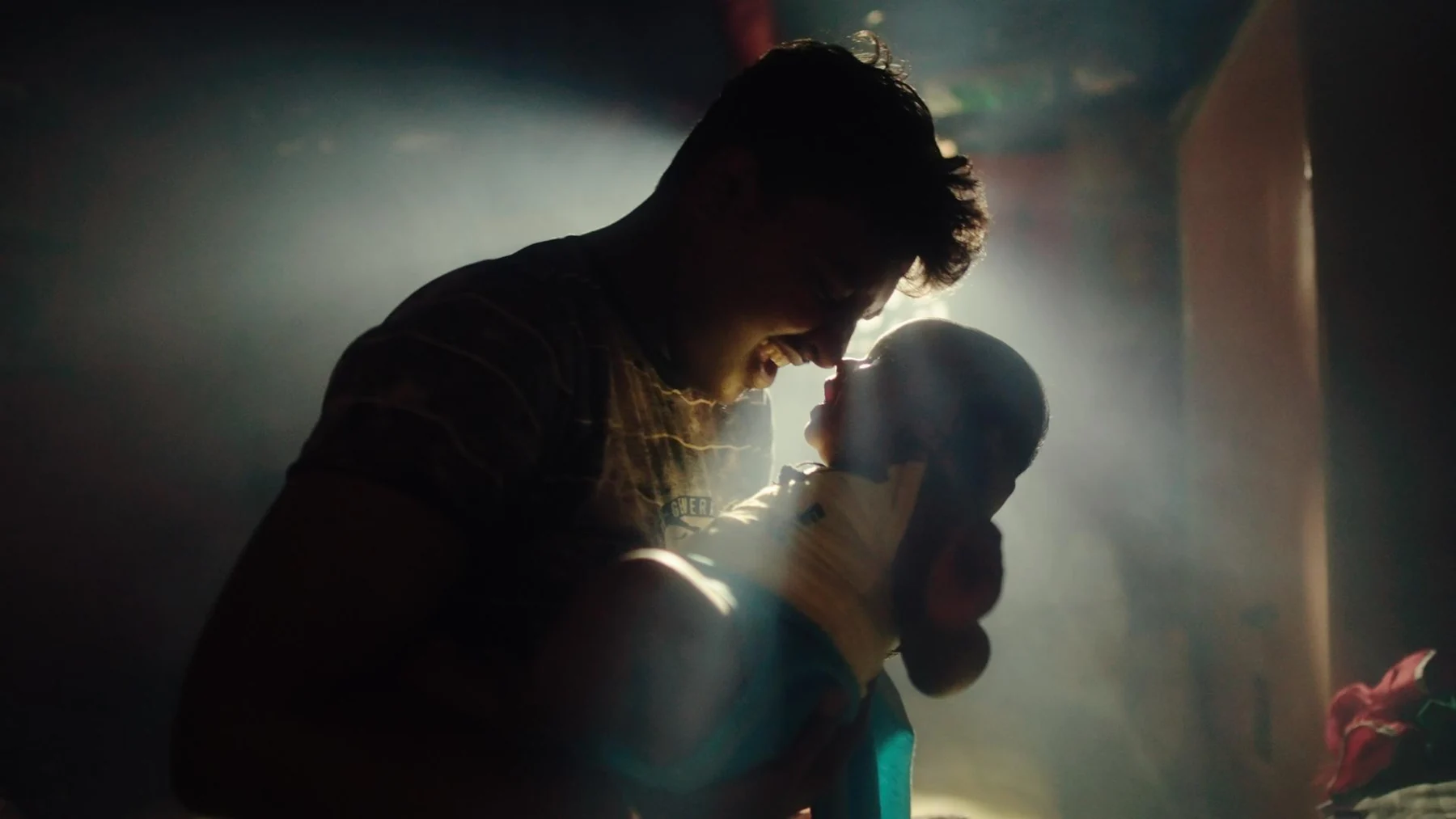 Kali — an intimate, backlit moment between two characters