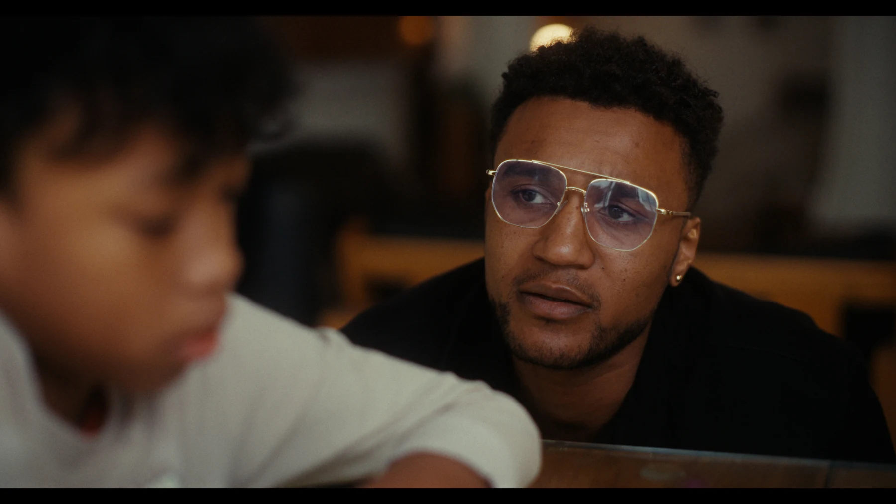 Indispensable — Nathan listens closely to a child at the table