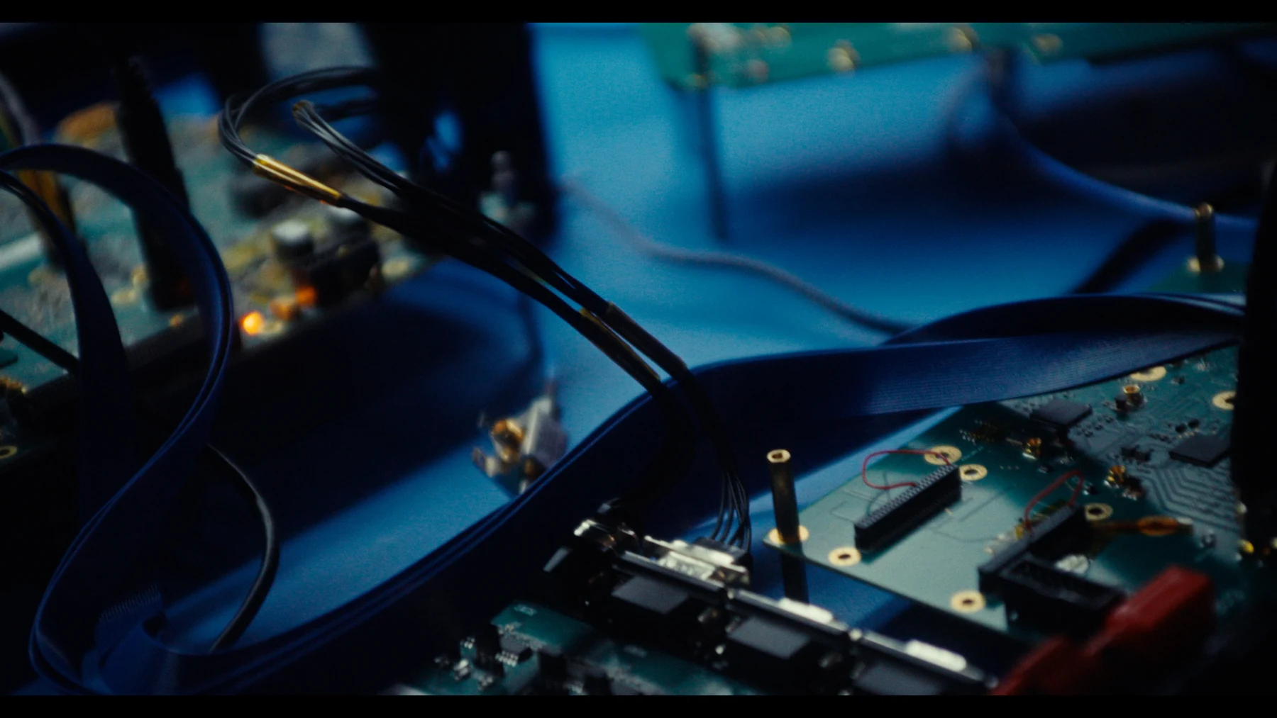 Indispensable — Blue-lit circuits and wires on a workbench