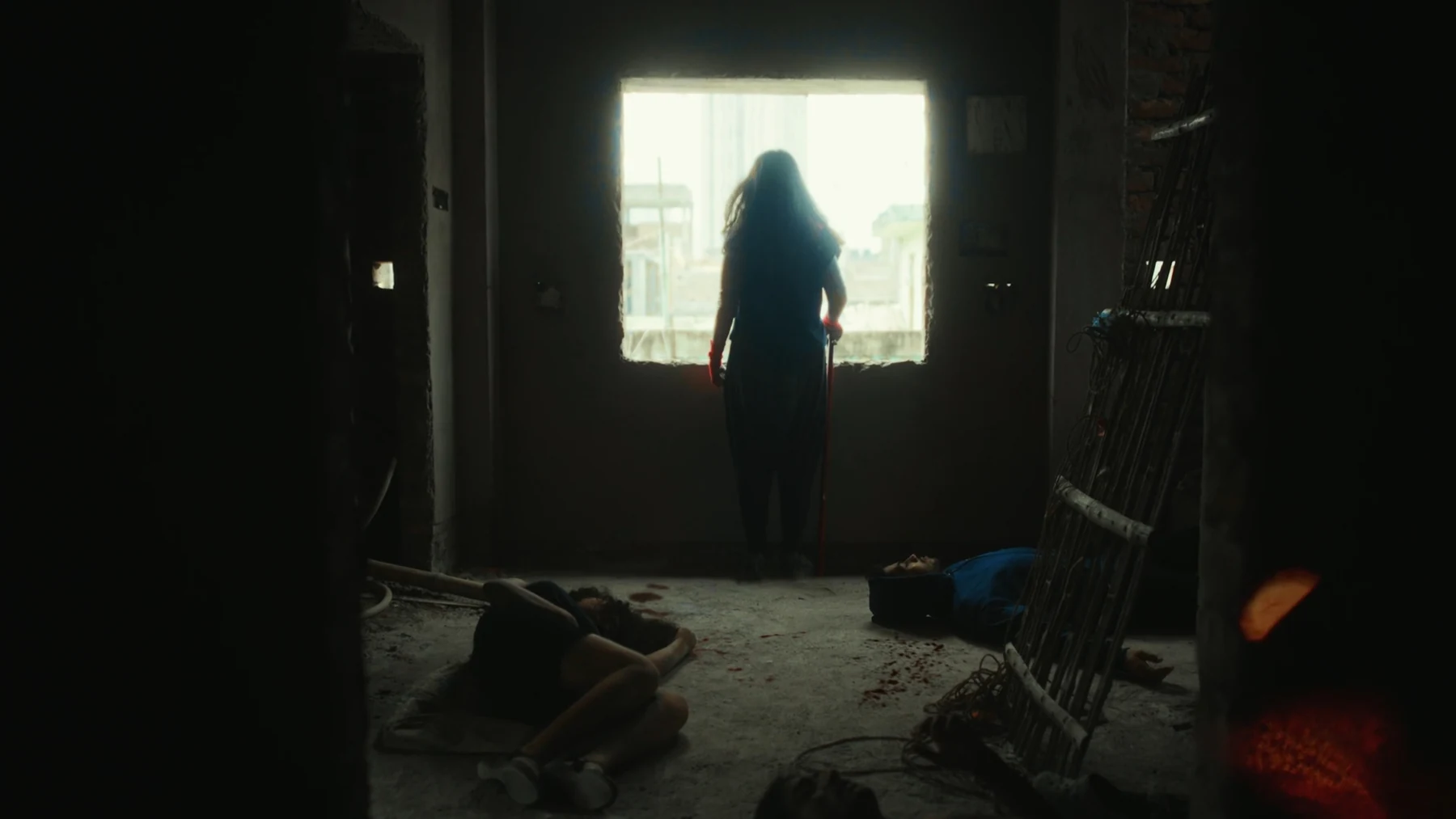 Kali — A figure framed by a bright window in a dark room
