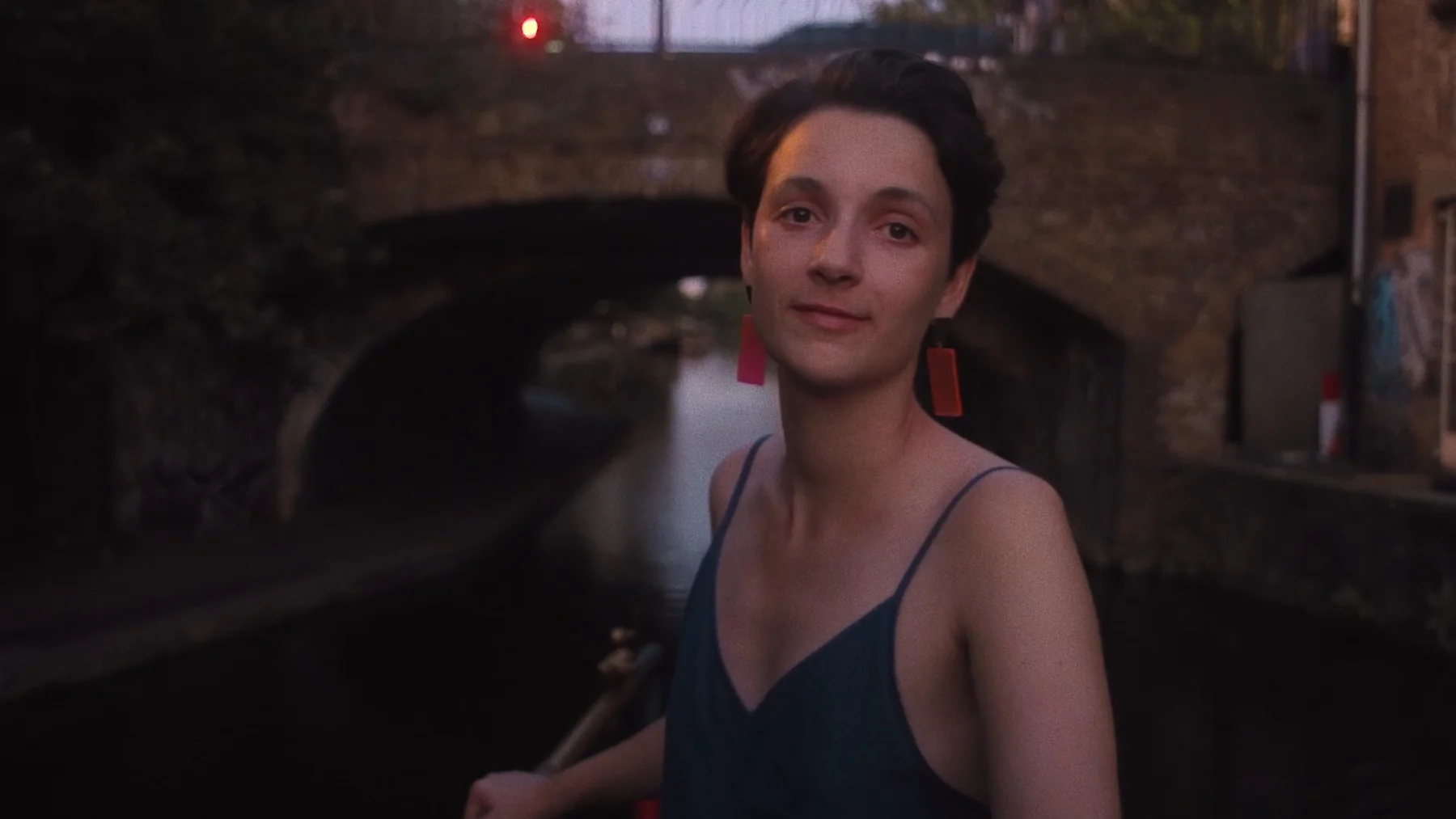 Trust Me — Anne Chataigné stands beneath a brick bridge outdoors