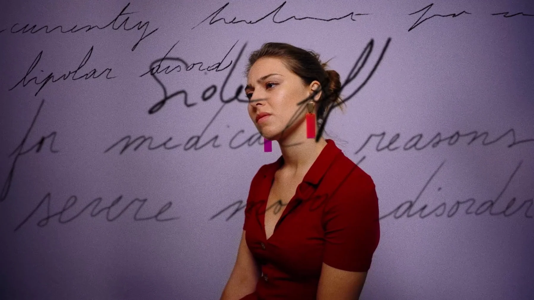 Trust Me — Anne Chataigné in a red top, with handwritten words projected behind her