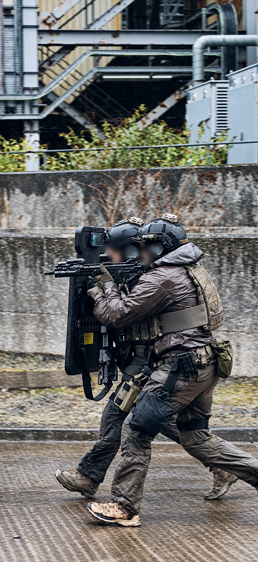 Shield team moving together; operator identities obscured