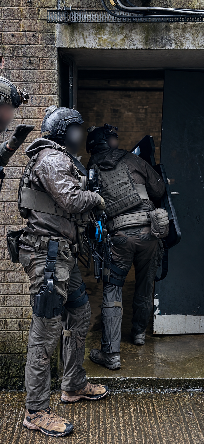Shield team entering a doorway; operator identities obscured