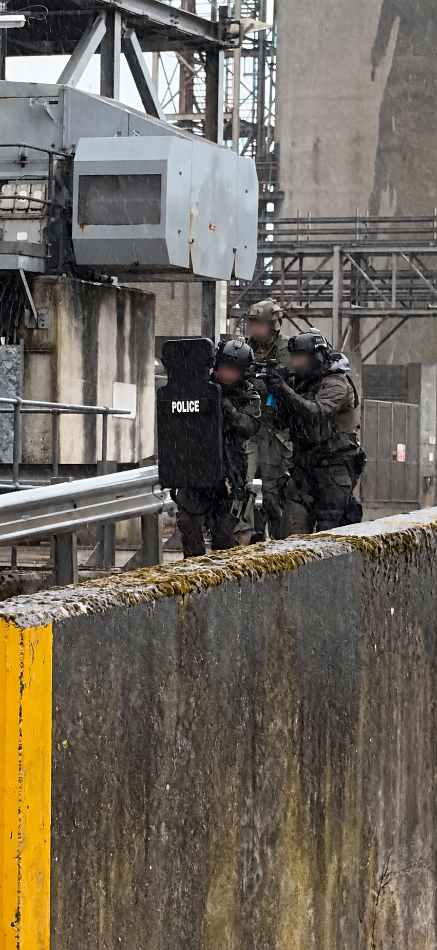 Shield team in rain; operator identities obscured