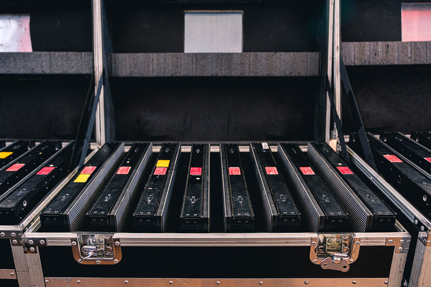 Black lighting equipment packed neatly inside a protective aluminum flight case.