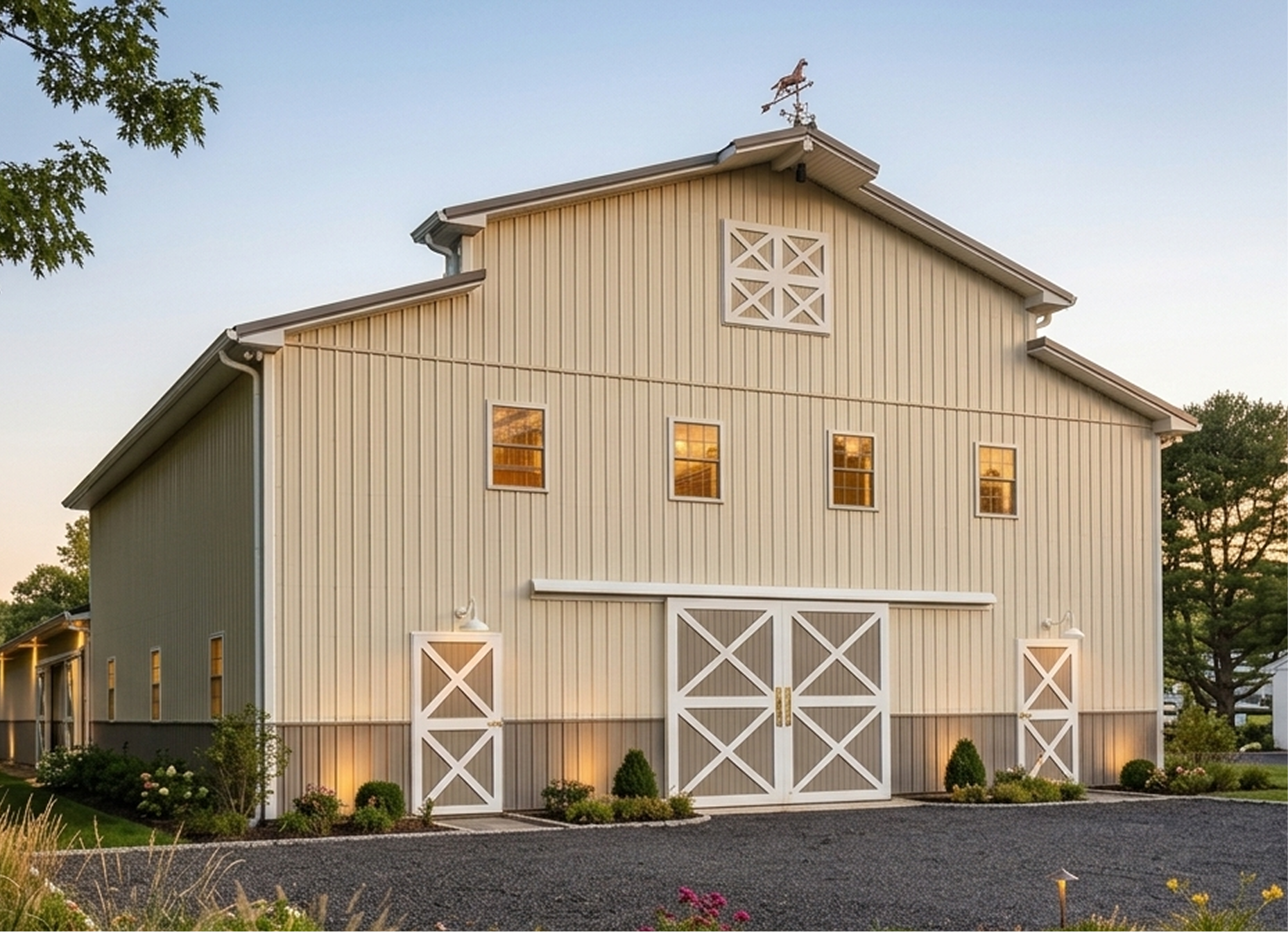 Large beige barn with white crossbuck doors, four windows, and a horse weather vane on the roof.