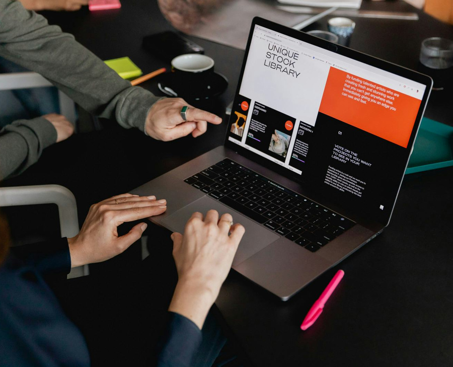 Colleagues setting up accounting software together on a laptop