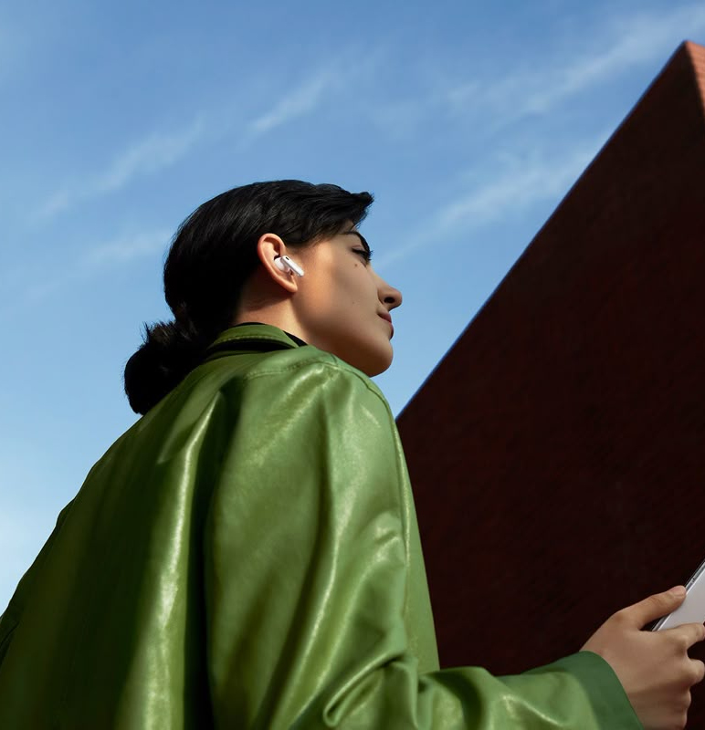 A business owner checking their phone outside on a clear day