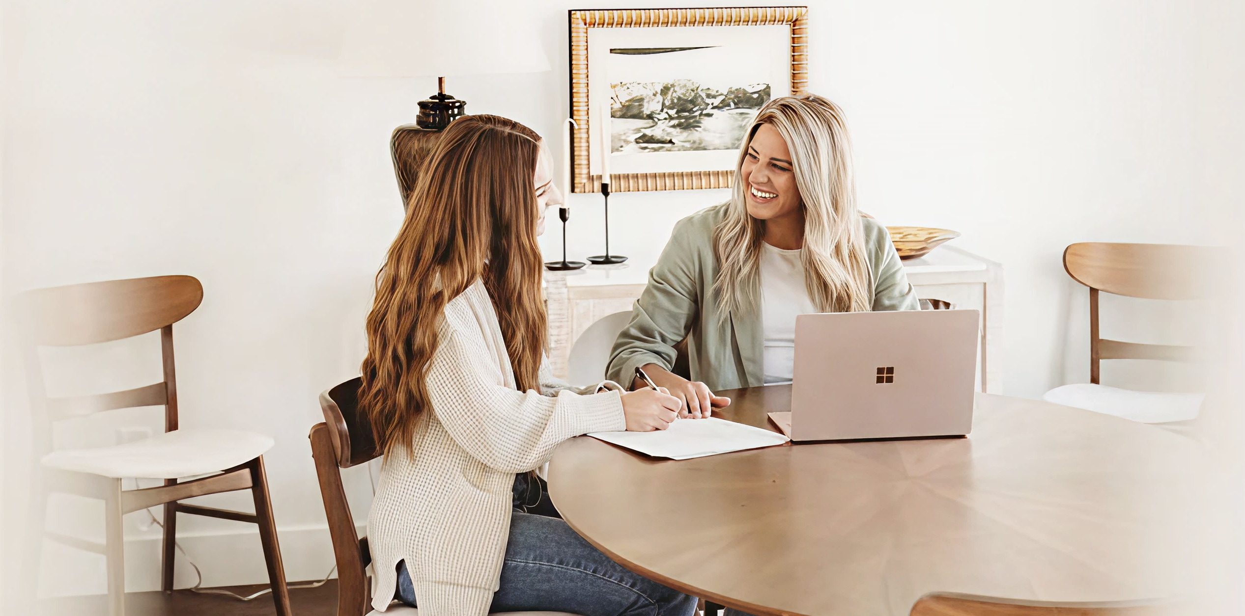 Shylie Harrison reviewing accounts with a client at a table