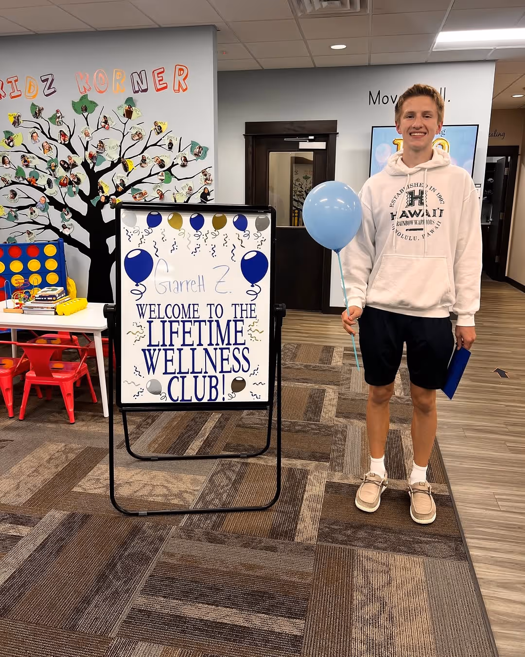 Child smiling with a balloon at a Gillis Family Chiropractic community event