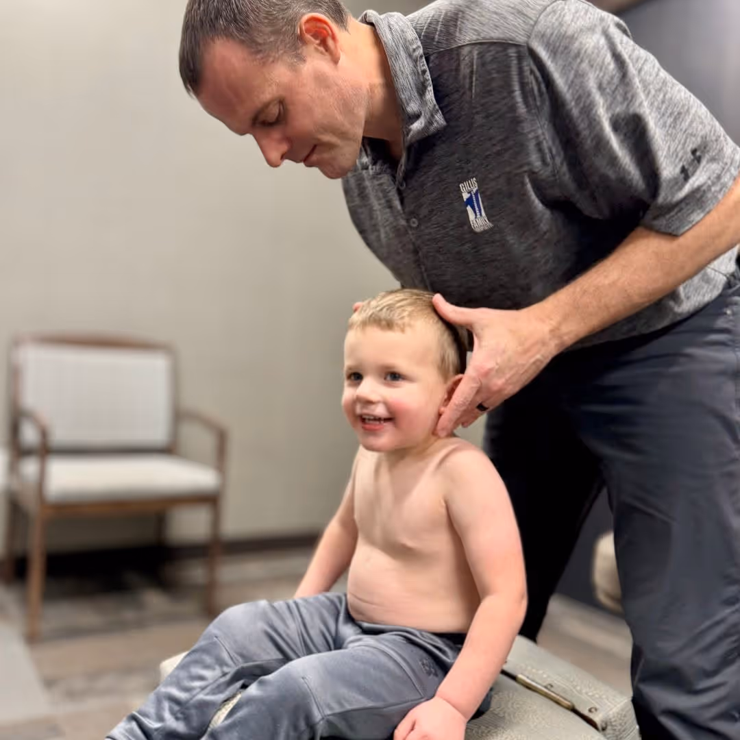 Chiropractor adjusting an infant