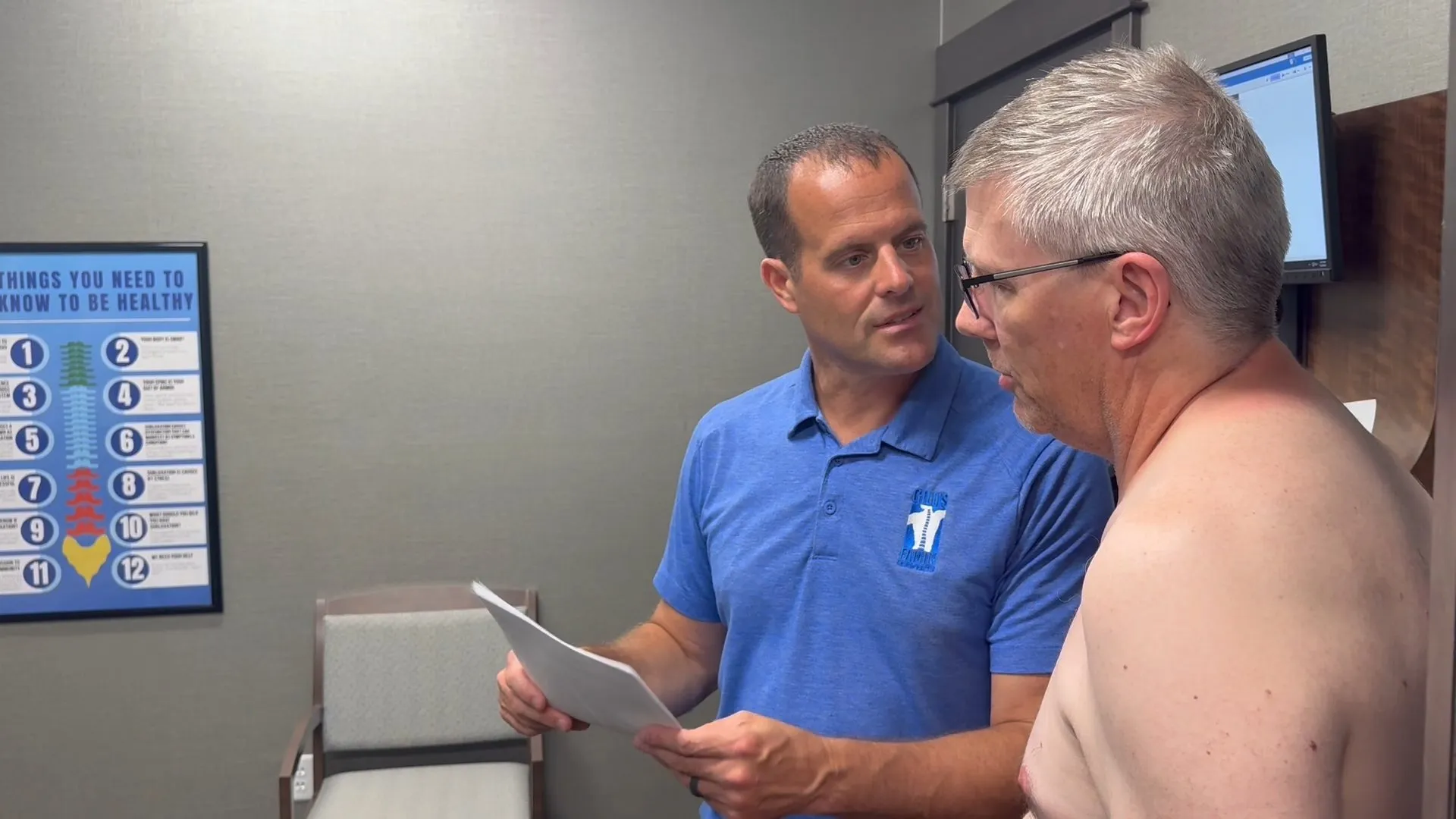 Chiropractor consulting with a patient