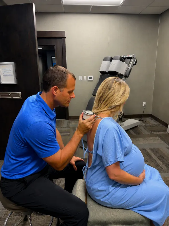 Pregnant patient receiving a chiropractic adjustment