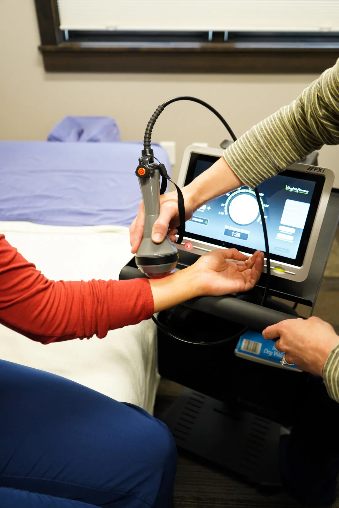 Laser therapy being performed on a patient's arm