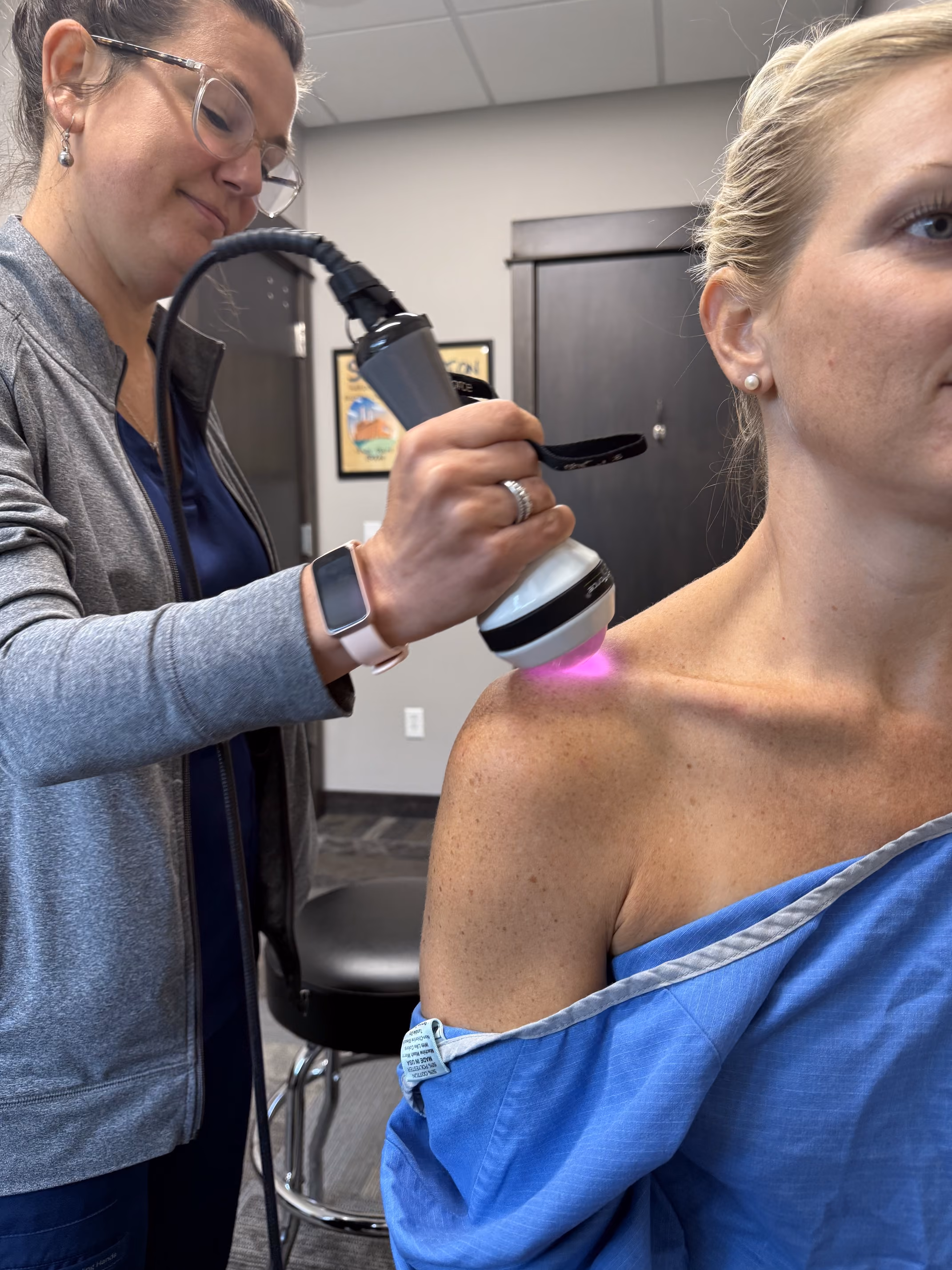 Laser therapy treatment on a patient's shoulder