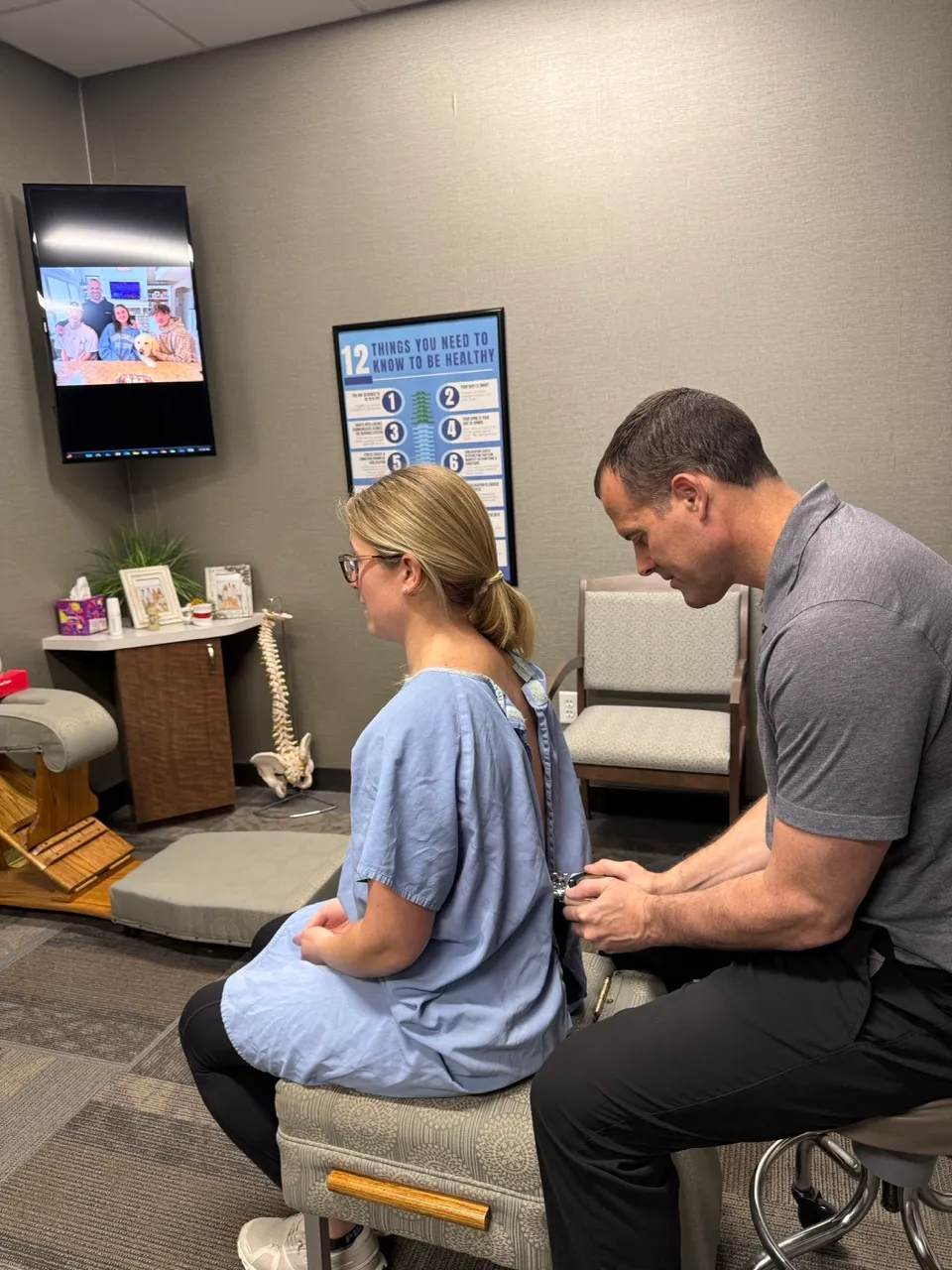 Chiropractor using a Nervoscope during an exam