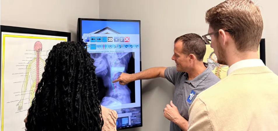 Chiropractor reviewing Report of Findings with a patient