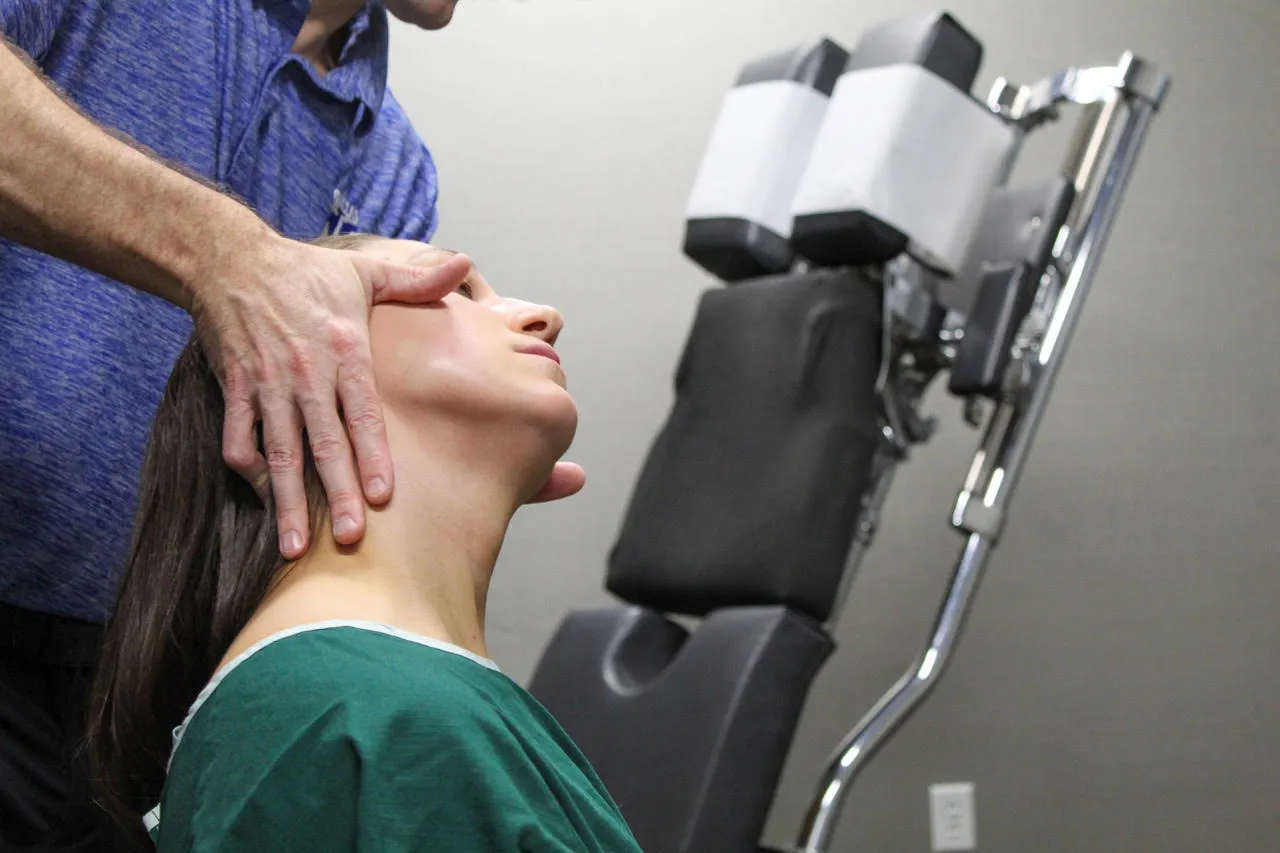 Chiropractor performing a gentle neck adjustment