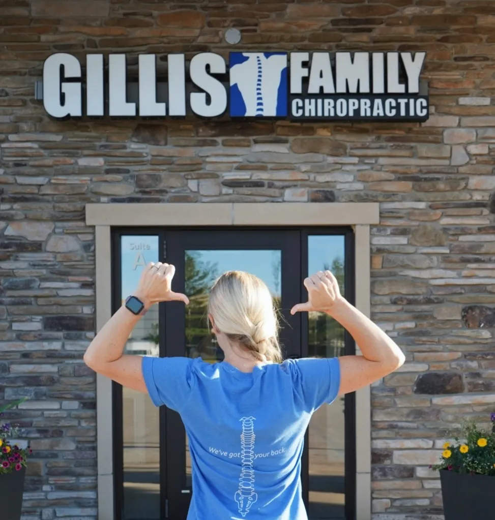 Gillis Family Chiropractic staff member waving outside the office