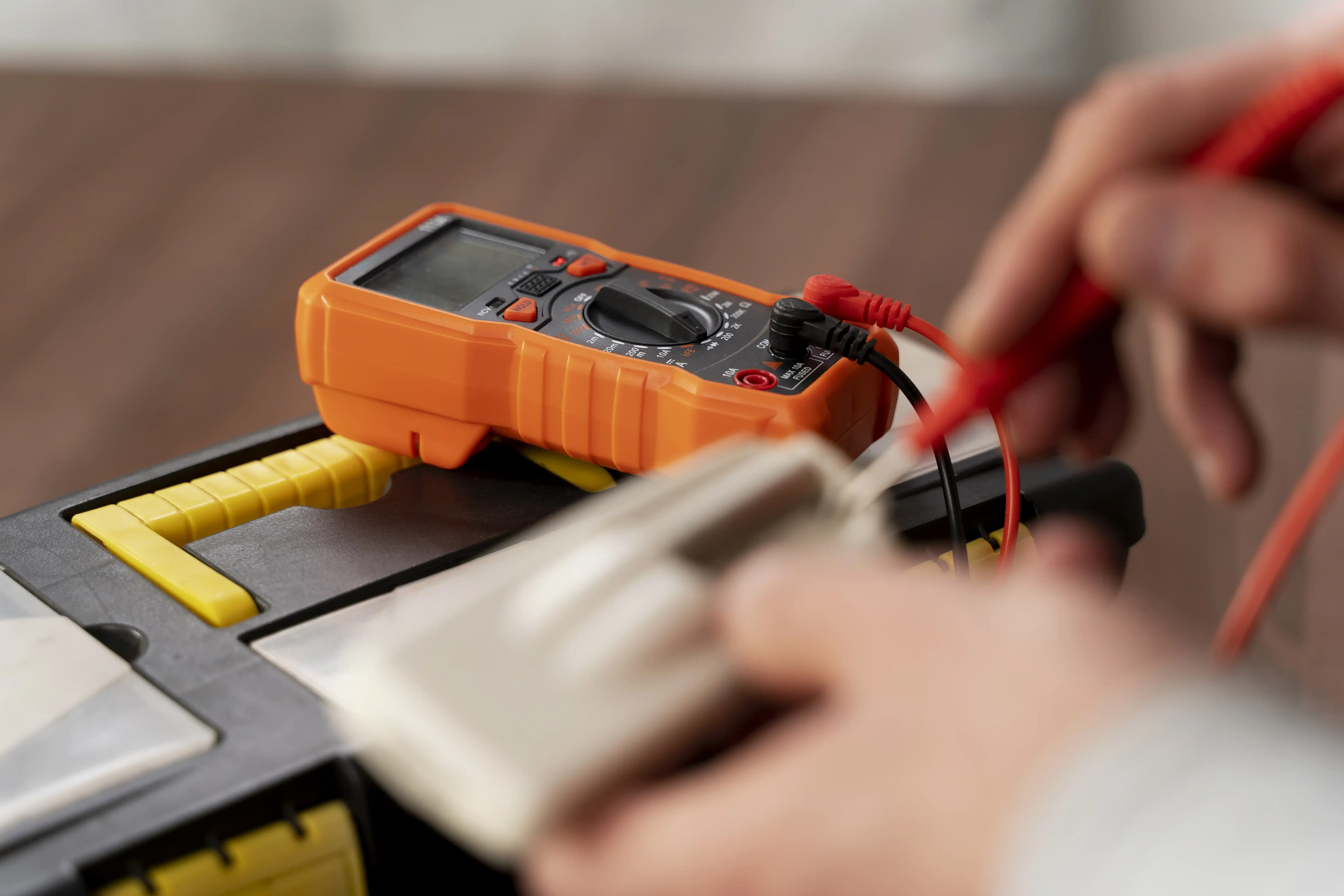 Electrician testing a power point with a multimeter