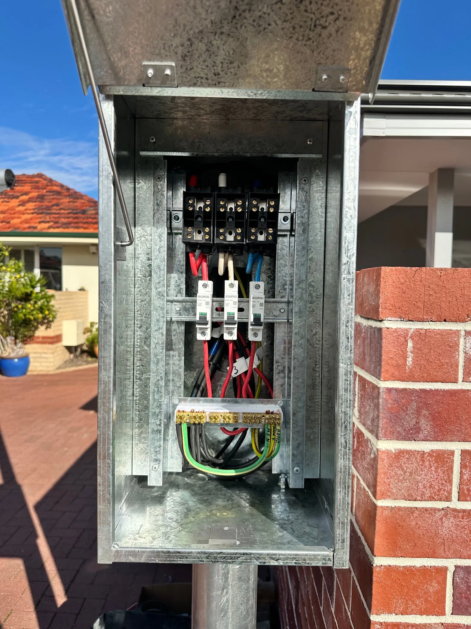 Open switchboard with the cover off showing circuit breakers and wiring
