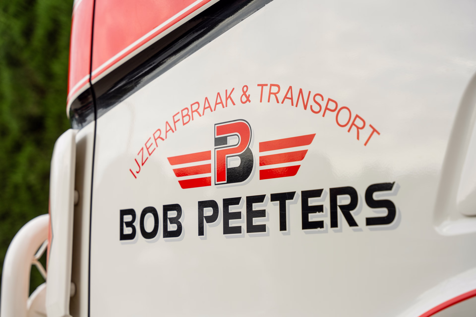 Logo van Bob Peeters IJzerafbraak & Transport op de cabine van een vrachtwagen