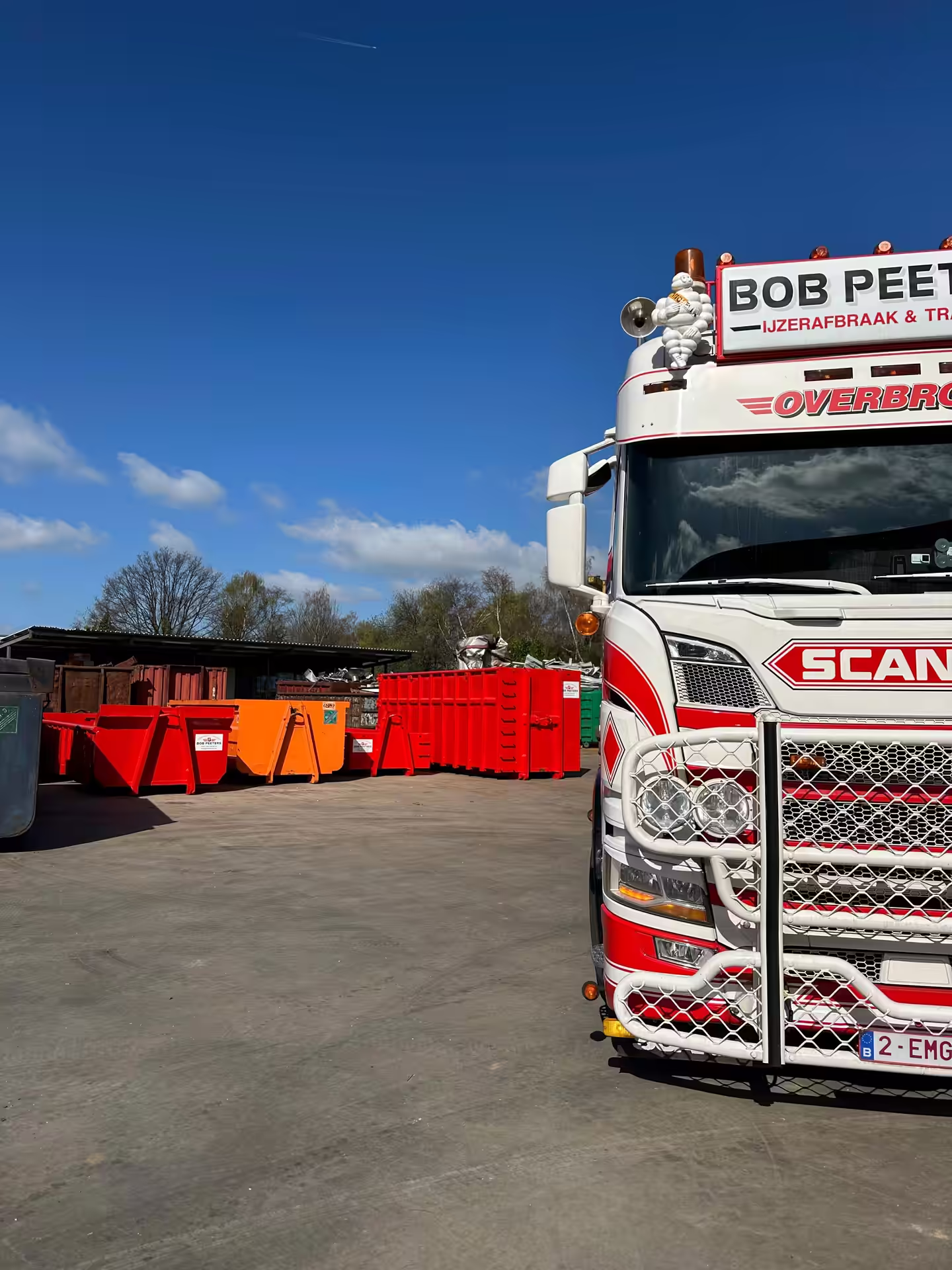 Scania-vrachtwagen van Bob Peeters voor een rij afzetcontainers op de werf