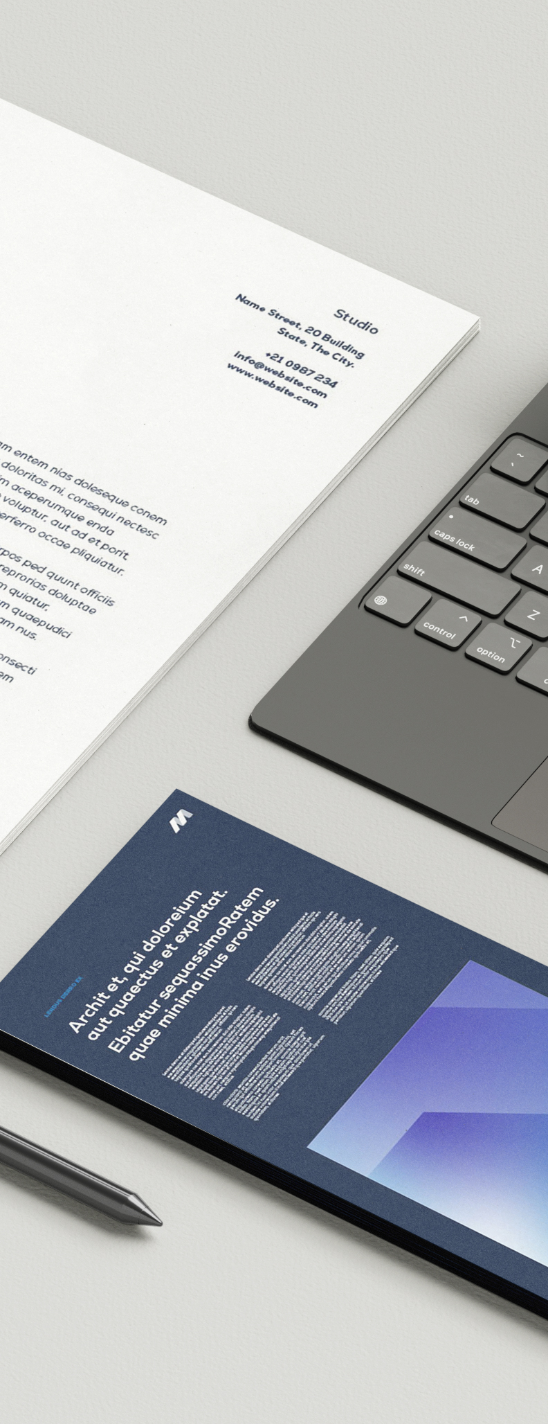 Stationery with white and blue printed sheets, a pen, and part of a laptop keyboard on a light surface.