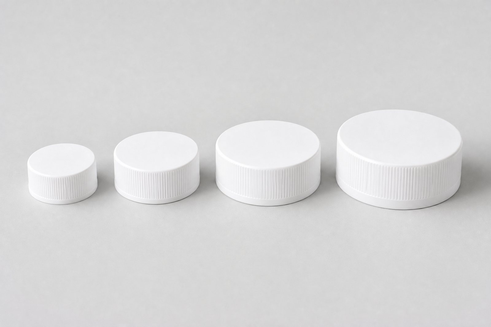 White bottle caps from 33 to 53 mm in ribbed, smooth, flip-top and child-resistant styles
