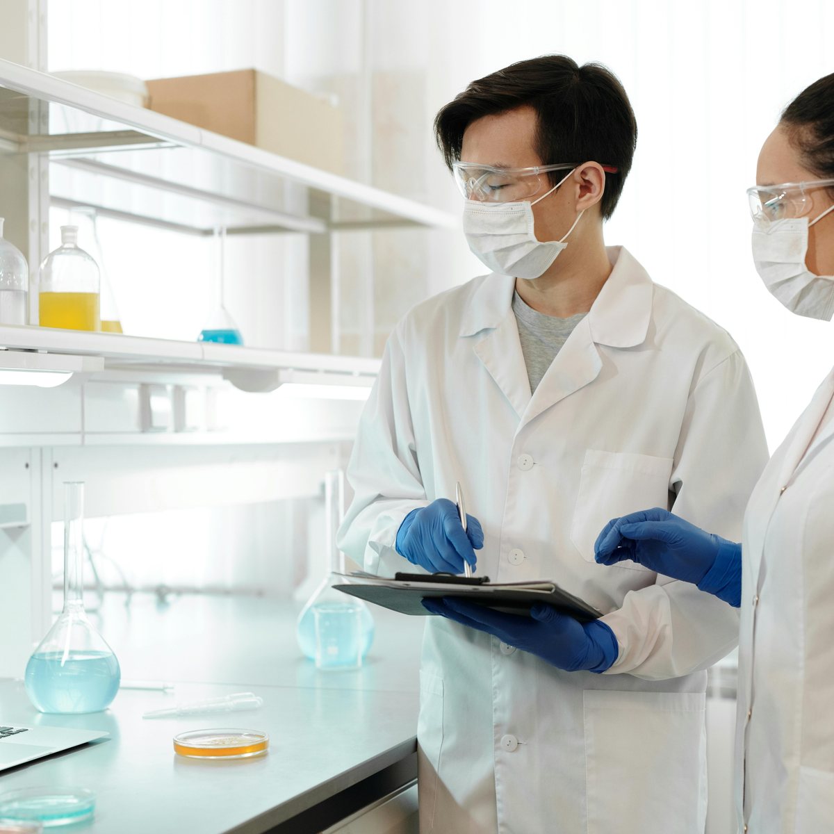 Quality specialists reviewing batch records in the lab
