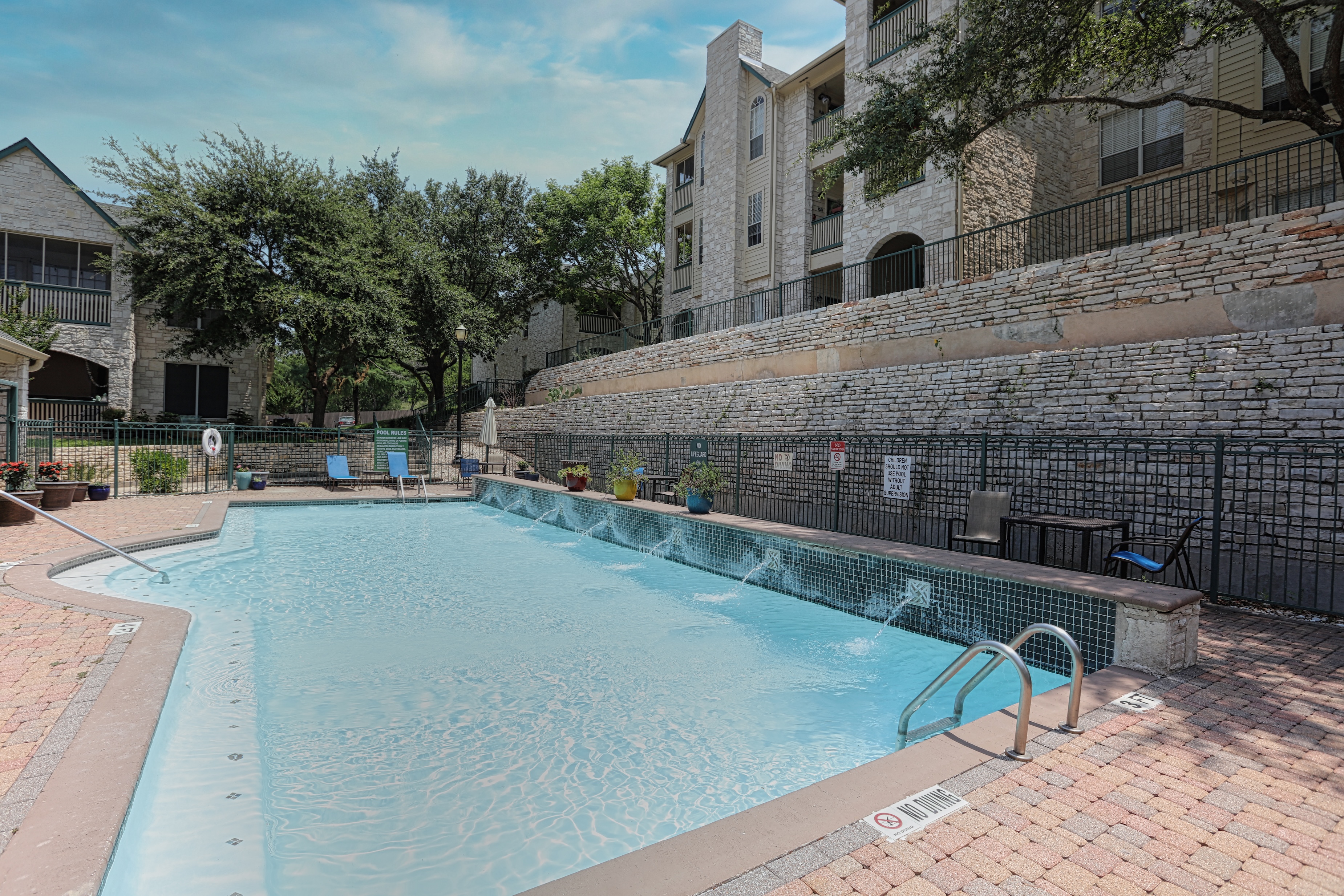 Pool area with fountains and apartment buildings