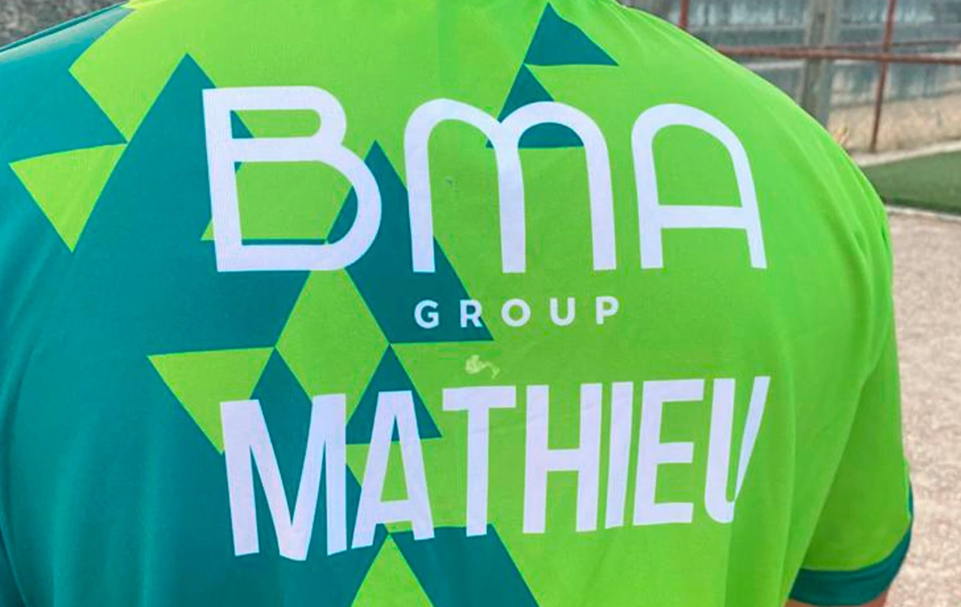 Back of a green football jersey printed with the BMA Group logo