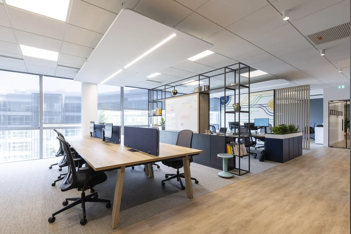 BMA Paris showroom with open-plan desks, large windows and a wooden shared table