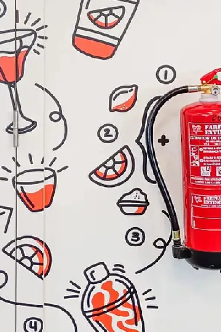 White wall with red and black cocktail illustrations around a fire extinguisher