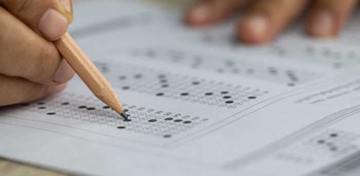 Student filling in answers on a multiple choice exam sheet
