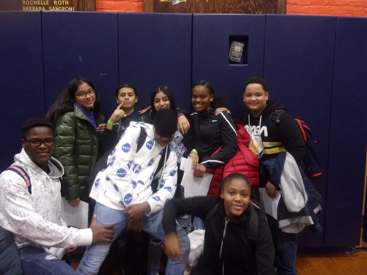 Group of middle school students posing together in a gymnasium