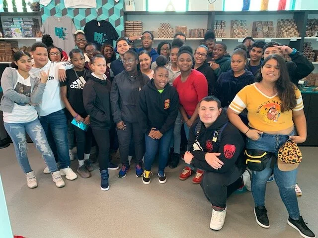 Students and adults posing together during a school field trip