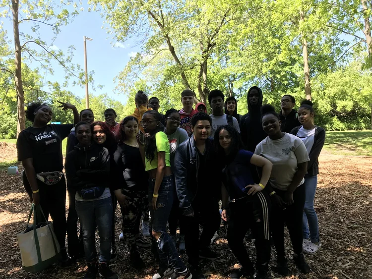 Students posing together outdoors during a school field trip