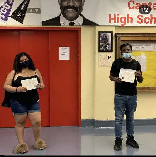 Two students holding certificates at Capital High School
