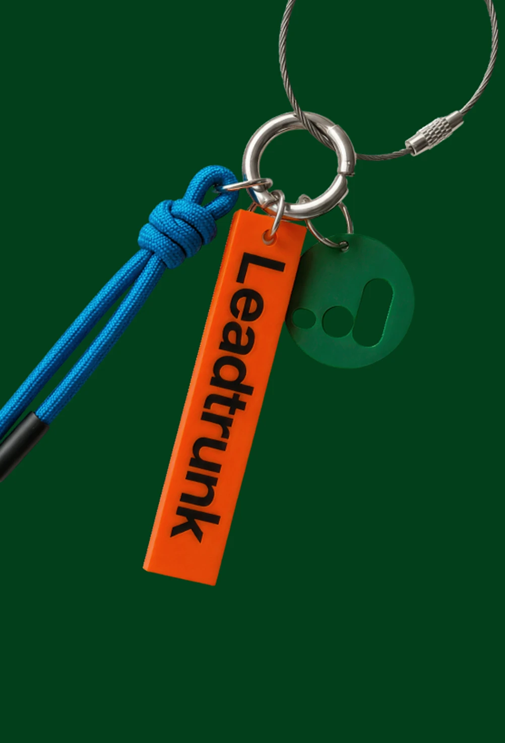 Keychain with silver ring, blue cord, orange tag reading 'Leaptrunk', and green round tag.