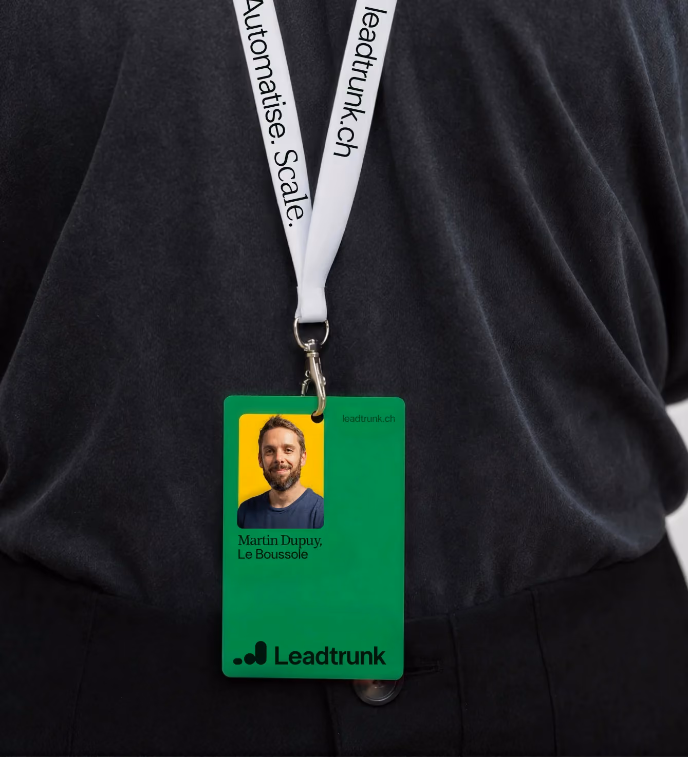 Leadtrunk branded lanyard and ID badge worn around the neck.